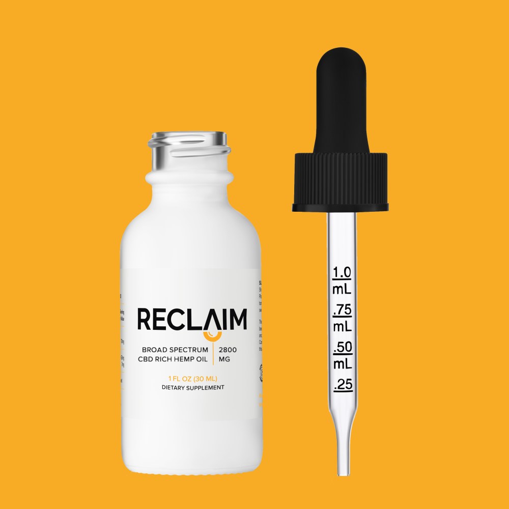 Reclaim Labs 2800mg Broad Spectrum CBD Oil with dropper on orange background
